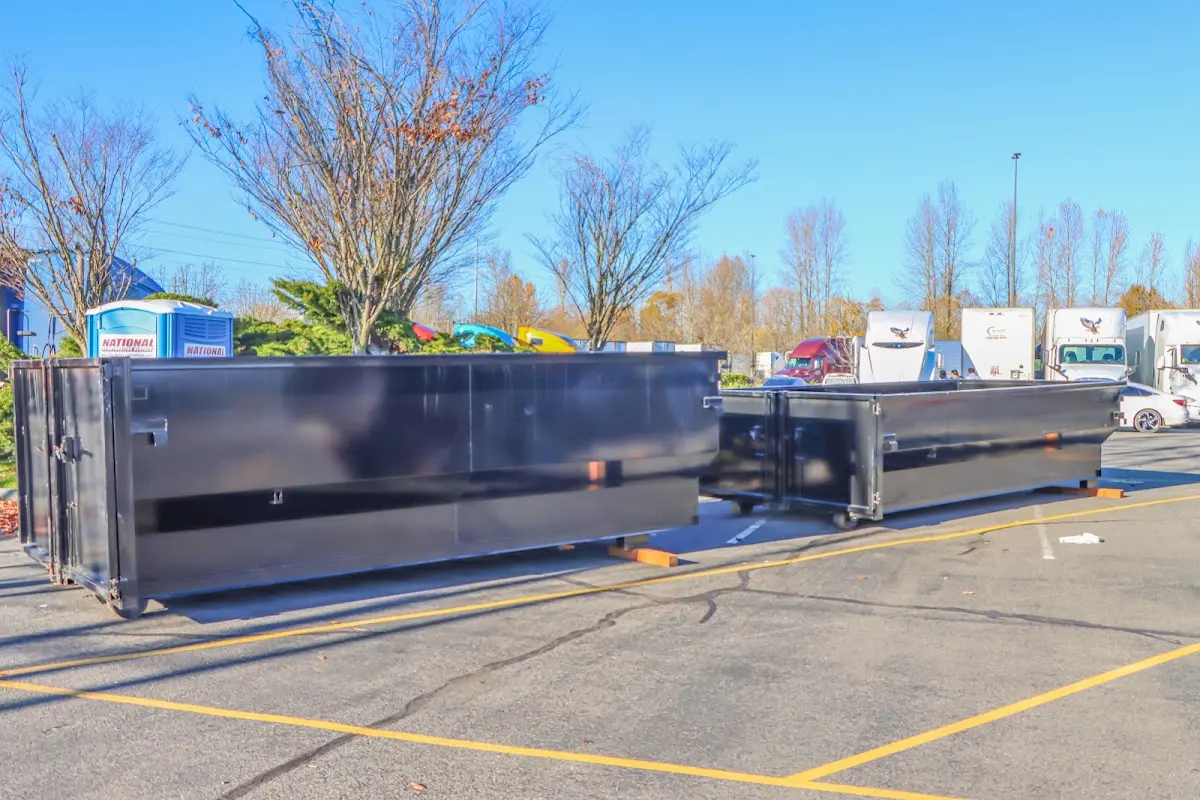 Professional dumpster rental service with roll-off container on residential driveway in Fairfax